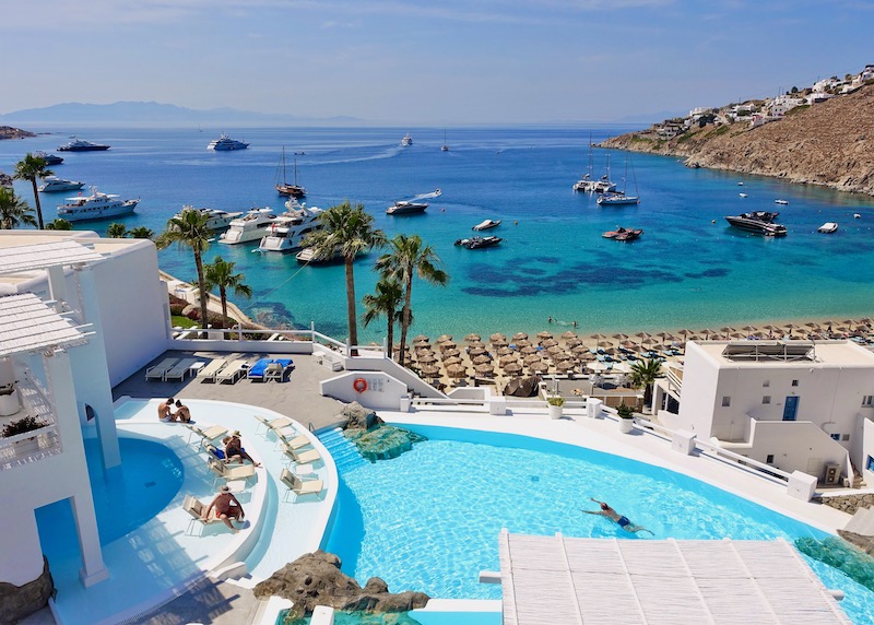 The main pool and view of Psarou Beach from Mykonos Blu
