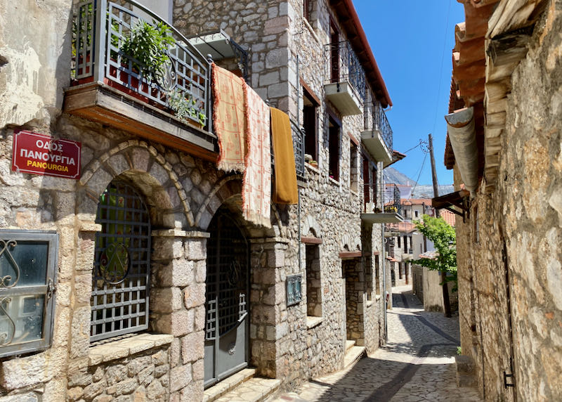 Medeival-looking stone buildings in a narrow alleyway 