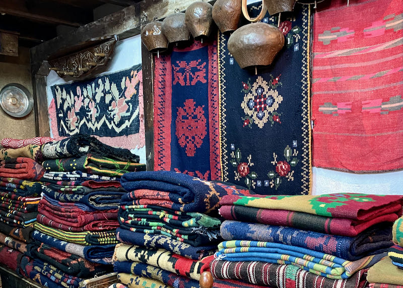 Stacks of colorful antique blankets in a shop display