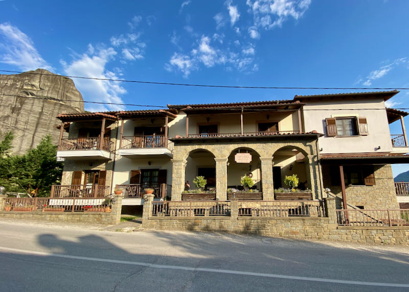 A roadside hotel with stone arches and wooden balconies