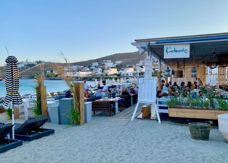 Outdoor diners at a becahfront restaurant in Mykonos