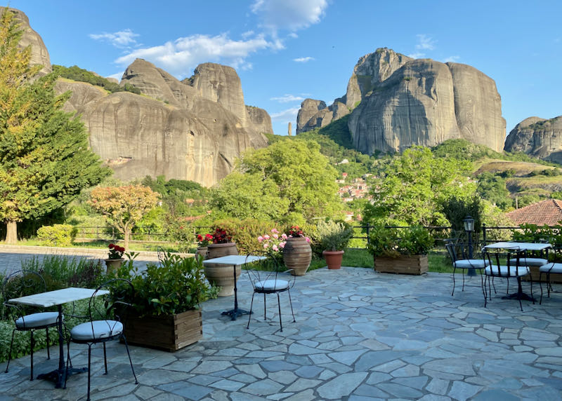 Stone patio with the rock formations of the Meteora in the background