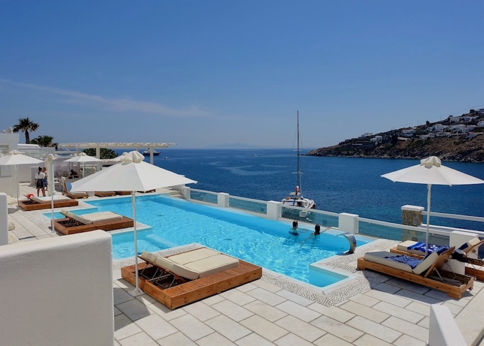A pool at Nissaki with a view of Psarou Bay