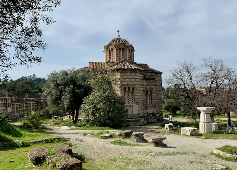 Old byzantine church, surrounded by stone ruins and greenery