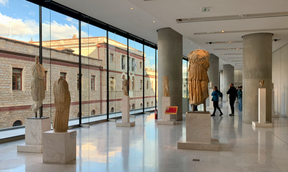Sculptures on display in front of a large window