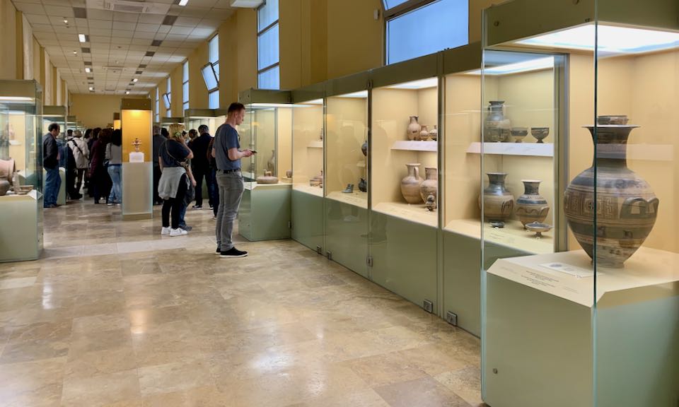 People look at artifacts in museum display cases
