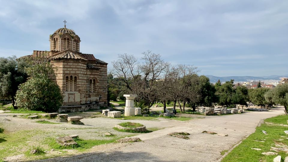 Old Byzantine domed church with pillars and stone ruins in front