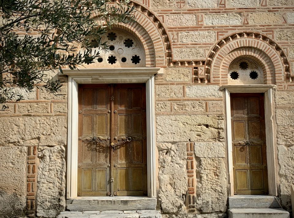 Detail photo of Byzantine church doors, featuring intricate stone and woodwork.