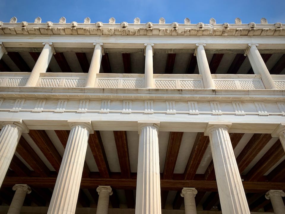 Detail shot of the beamed portico ceilings and the marble columns on the Stoa of Attalos