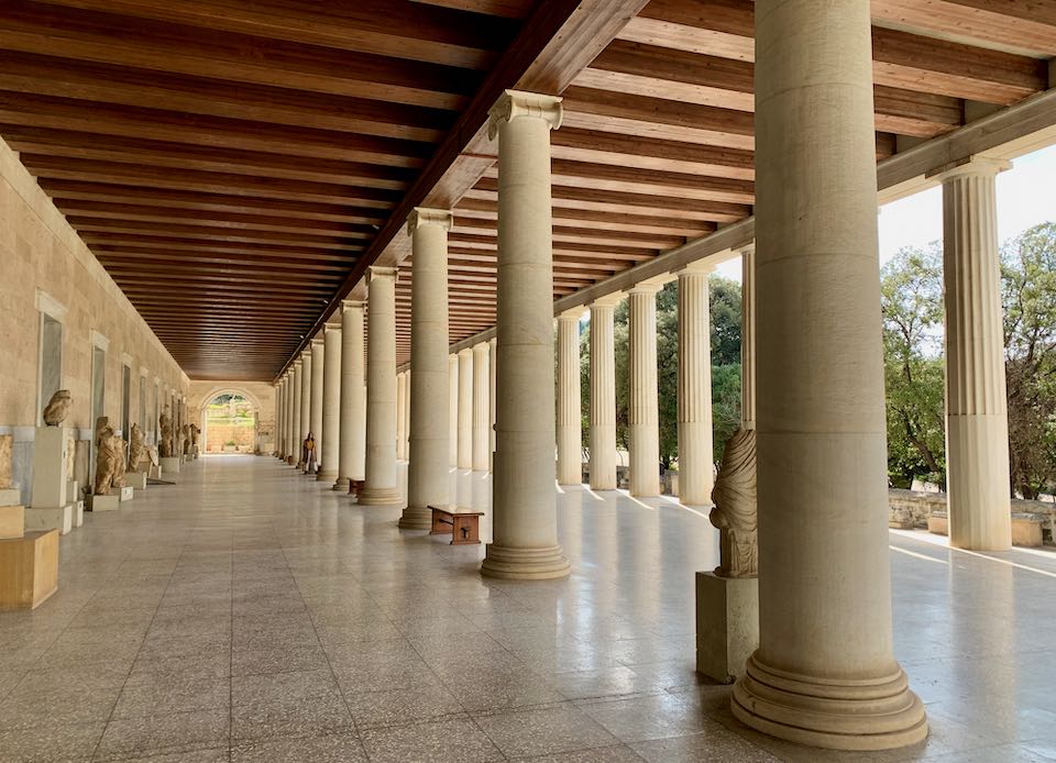 Colonnade with wood beamed ceiling and marble floors