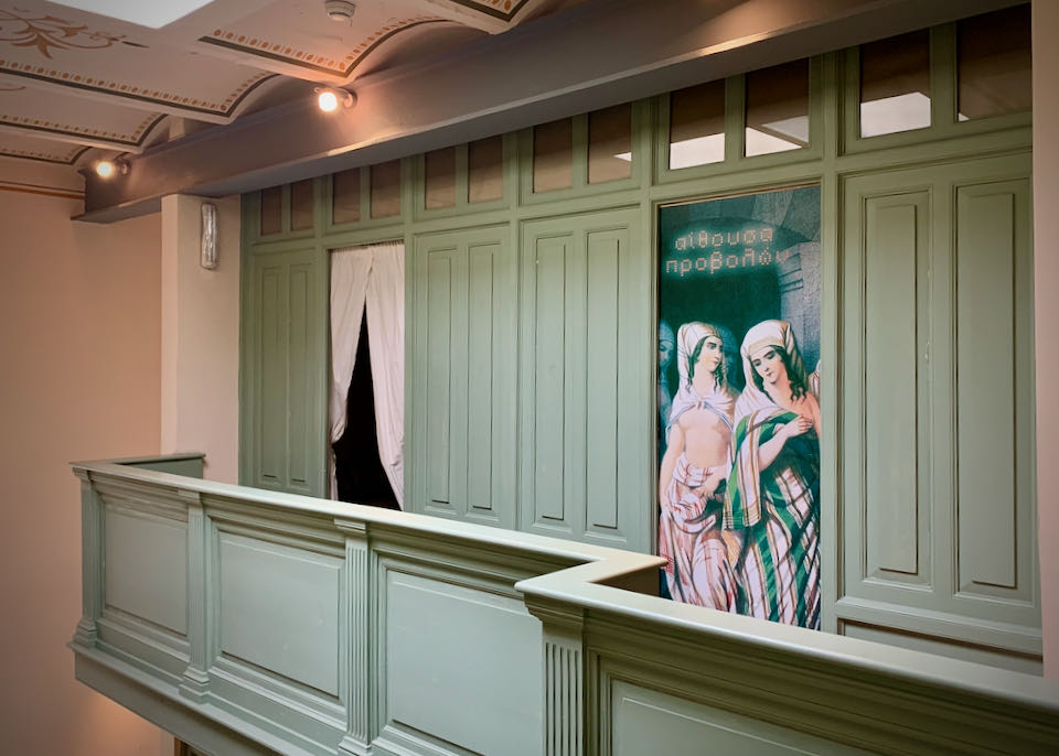 Green-panelled hallway with curtained doorways