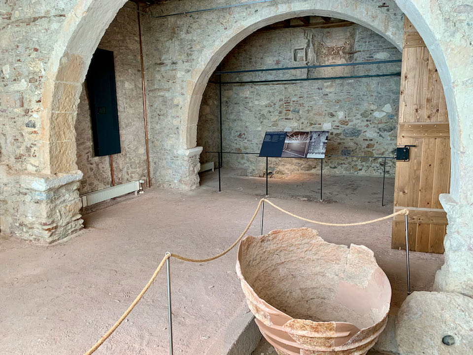Stone room with archways and a broken clay vessel