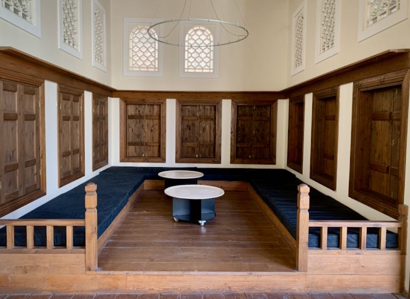Wooden room with built-in seating along the walls