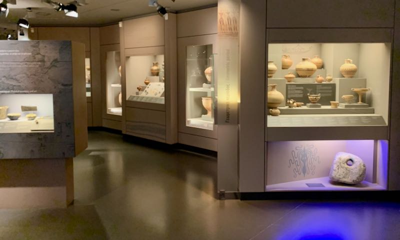 Early Greek pottery in museum display cases