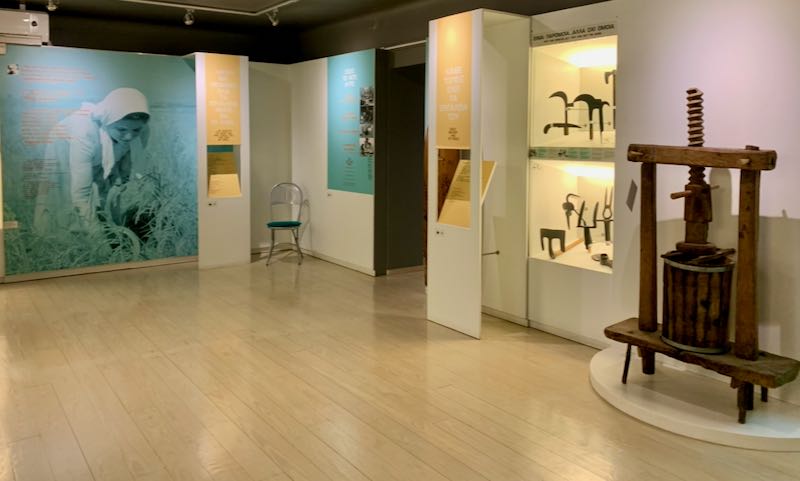 Museum gallery space with old traditional iron tools on display