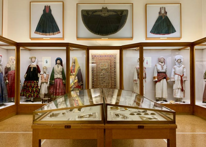 Museum cases filled with mannequins dressed in traditional Greek costume