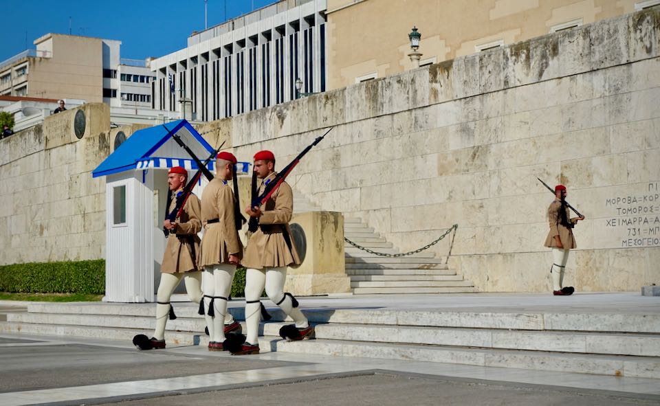 Guards marching in traditional Greek military uniform