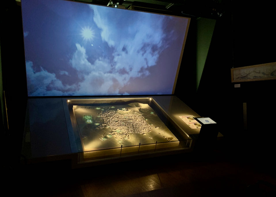 Digital display above a diorama of the city of Athens