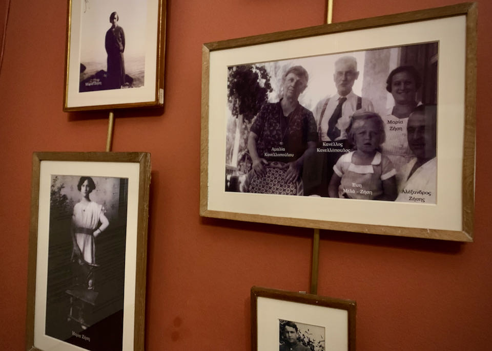 Old black and white family photos hang on a wall