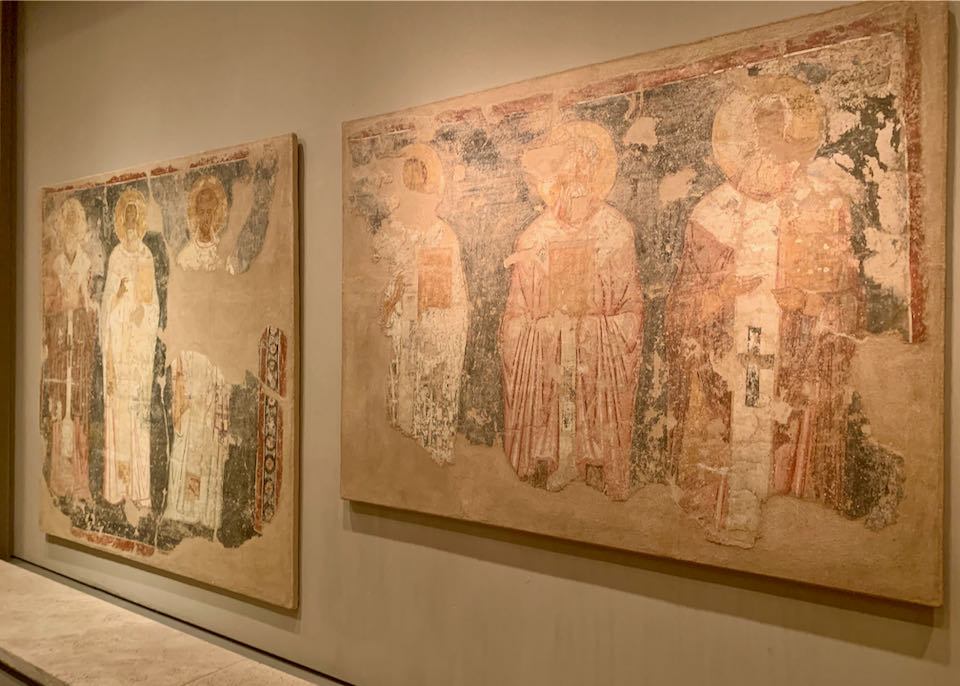 Fresco fragments displayed on a museum wall