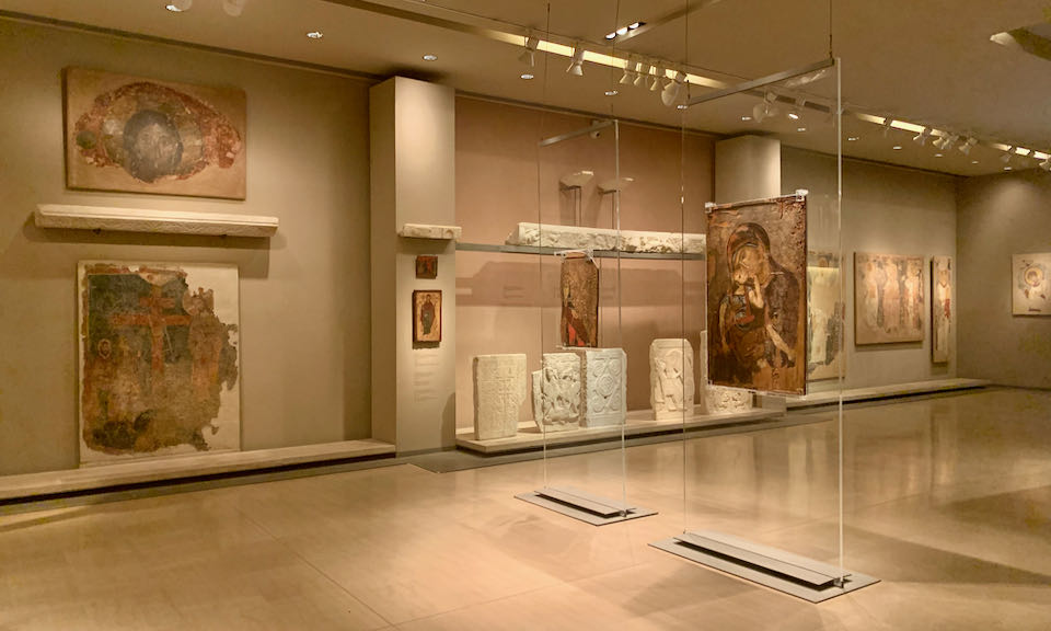 Room displaying Byzantine icons and religious marble fragments