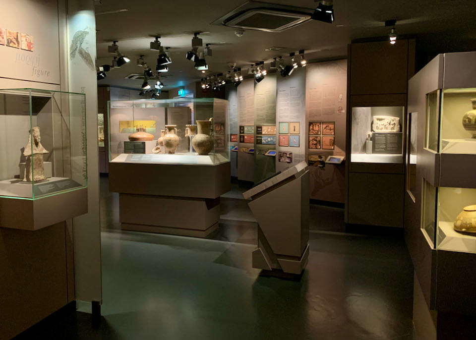 Museum room filled with display cases and colorful signage