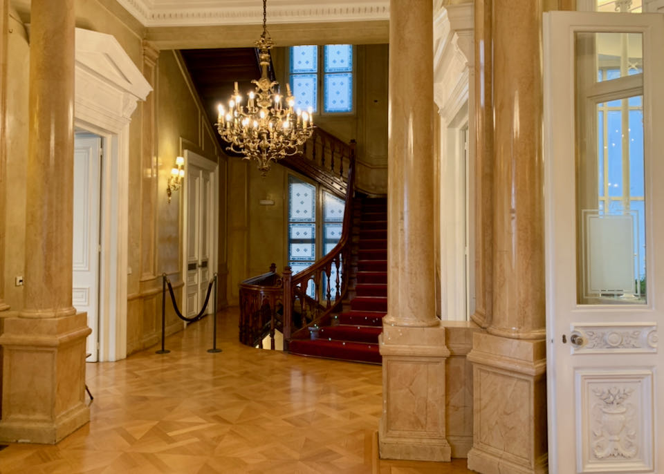 Elegant marble hallway with a circular wooden staircase
