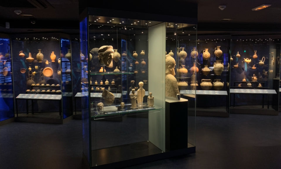 Room of display cases filled with terra cotta vessels