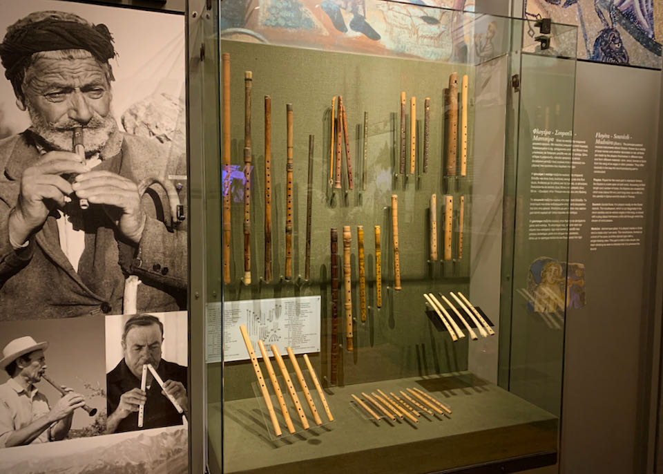 Traditional Greek flutes displayed in a museum case