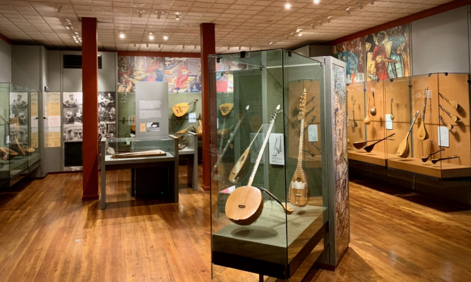Room of traditional Greek instruments in museum display cases