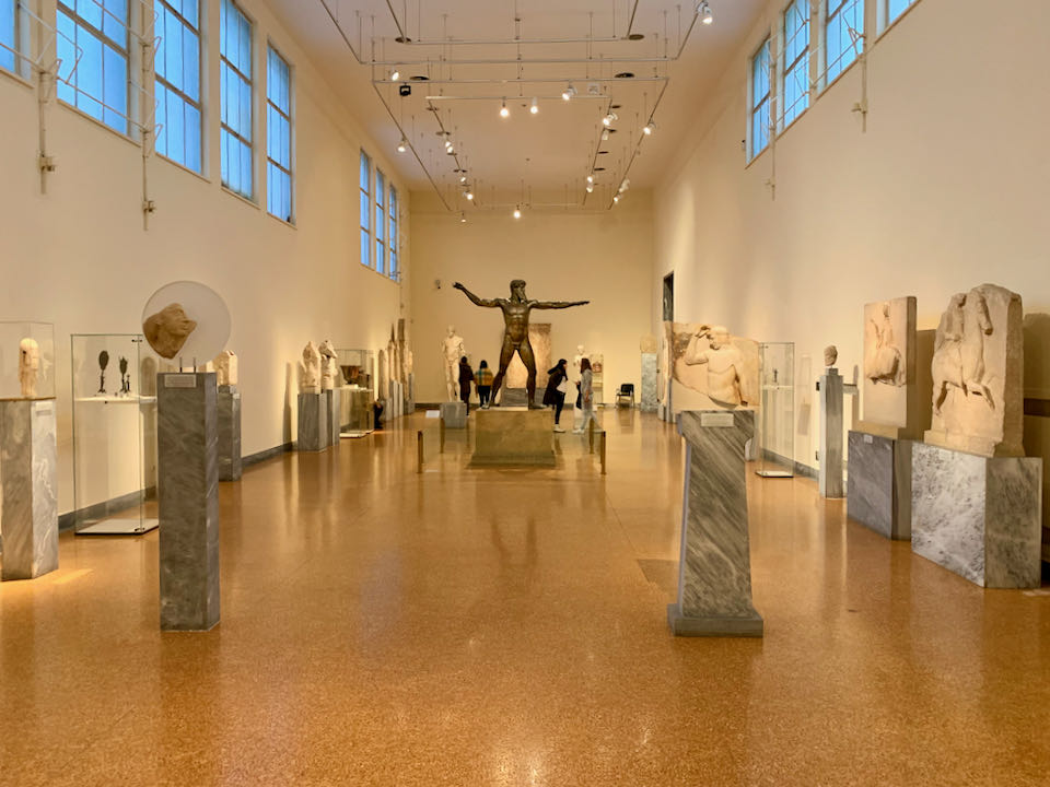 Room of sculptures, centered around a bronze sculpture of a man throwing a spear