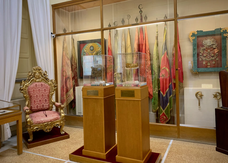Flags and crowns on display in  museum cases
