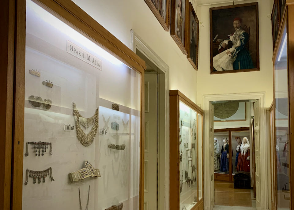 Hallway lined with jewelry display cases, leading to a room with costumed mannequins