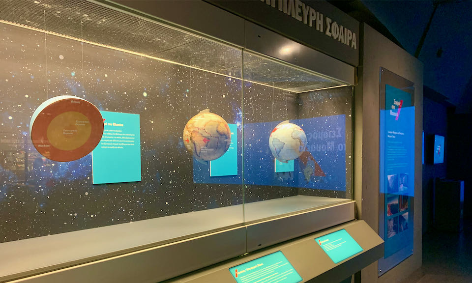 Models of planets on display in a museum case
