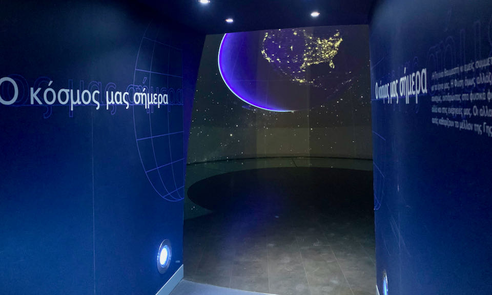 Doorway leading into a room with a model of the galaxy