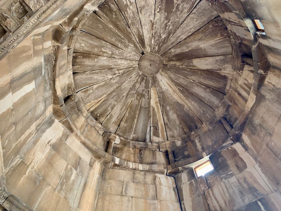 Interior of an ancient, domed, and stained marble ceiling.