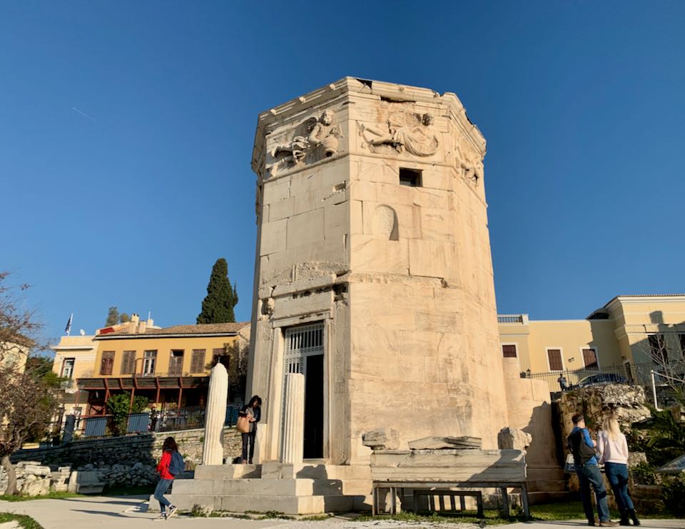 Visitors exiting a large marble tower