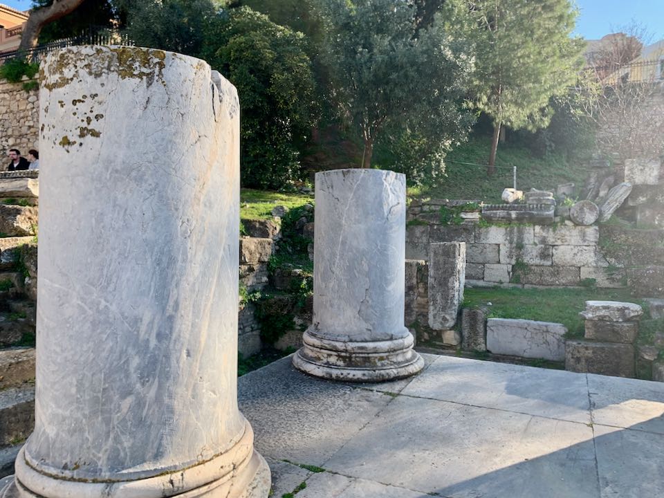 Short, stubby ruins of marble pillars.
