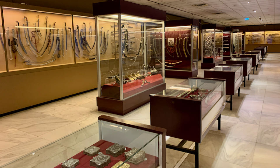 Rows of display cases housing military weaponry