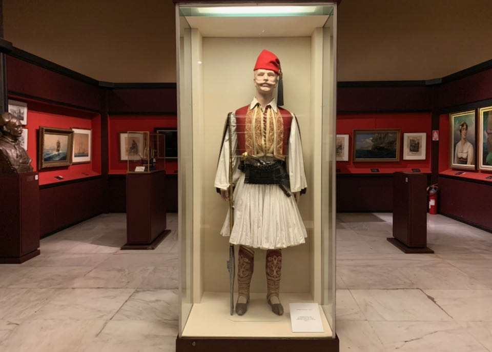 Traditional Greek military uniform on a mannequin in a display case