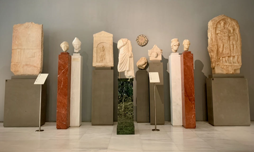 Statues displayed on pedestals in a museum