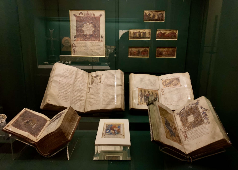 Antique books displayed in a museum case