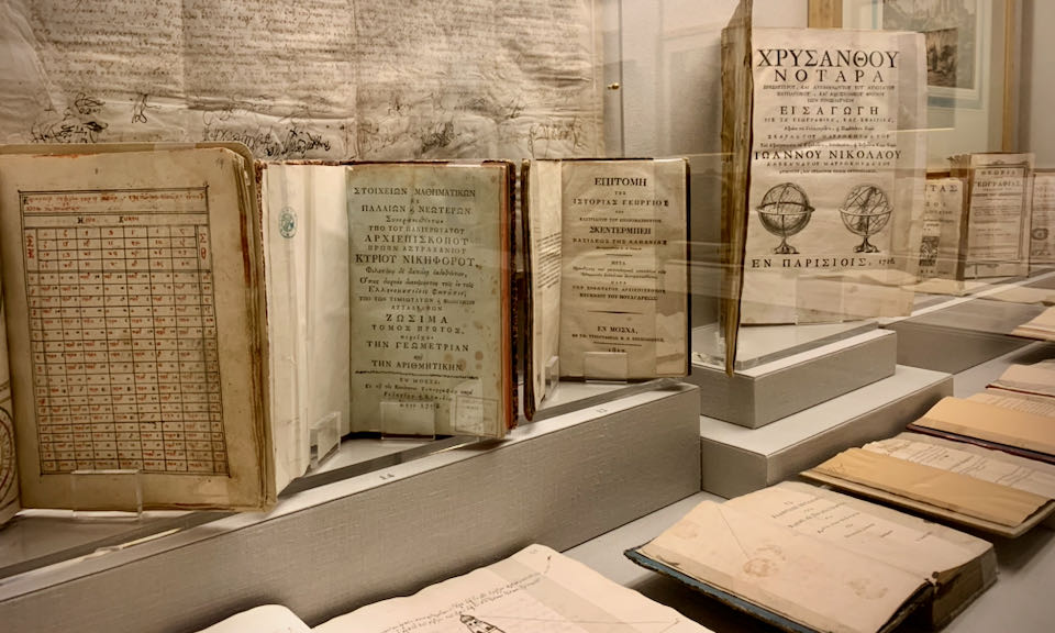 Antique books on display in a museum case