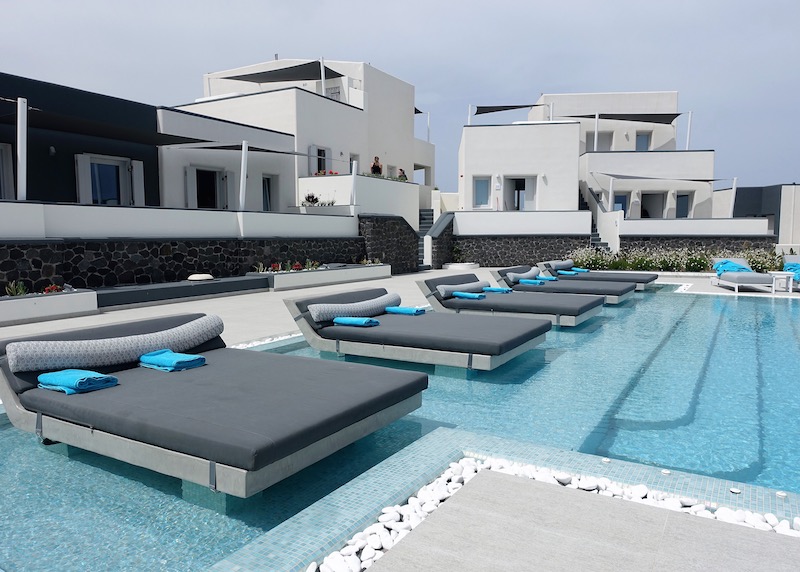 Floating sun loungers in the pool at Myst Boutique Hotel in Oia, Santorini