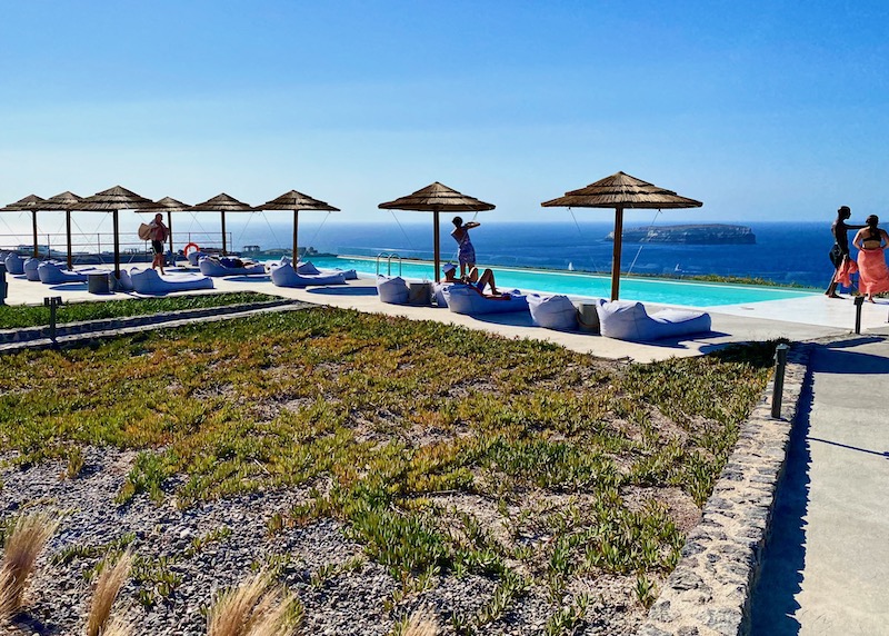 View of the caldera and pool at CocoMat Hotel Santorini in Akrotiri
