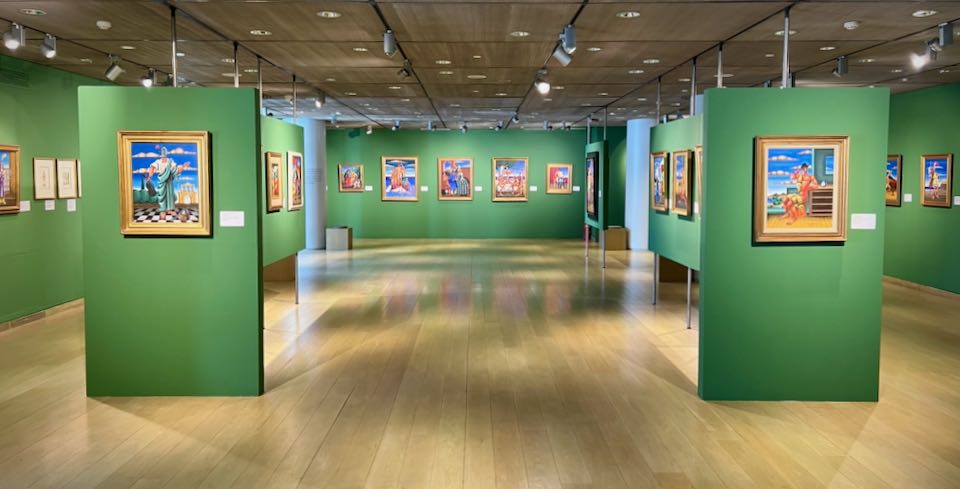 Museum gallery with vibrant green walls, hung with colorful contemporary paintings