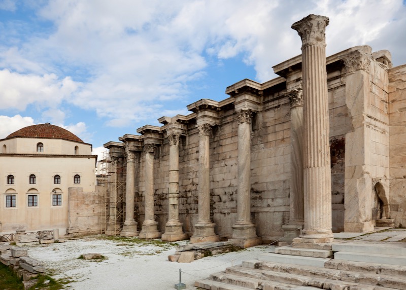 Marble Corinthian Pillars next to a Byzantine church with a domed roof