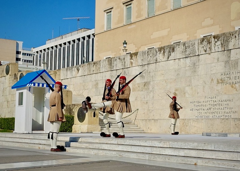 Men marching in traditional Greek military uniform