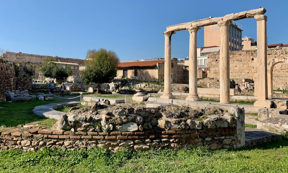 Pillars and low ruins of stone foundations in an archaeological site
