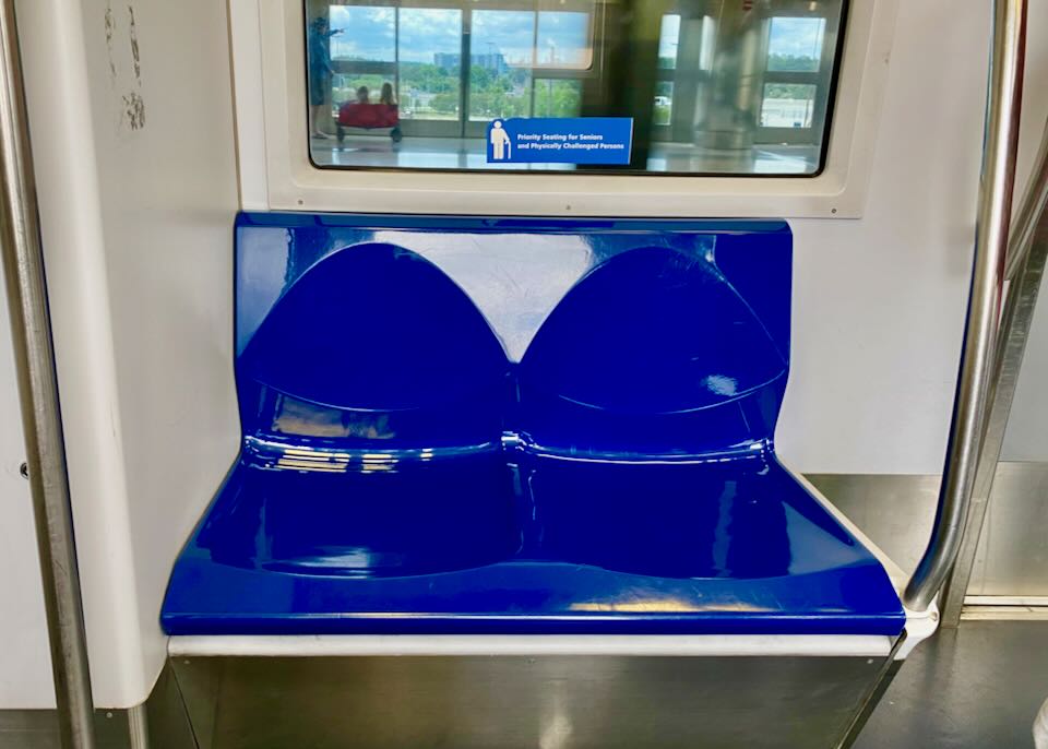 Blue priority seating bench and sign.